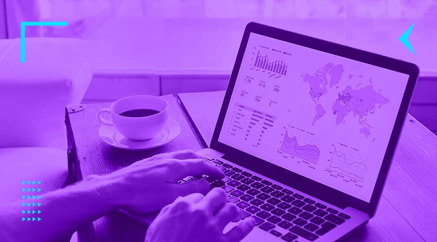 Website cost featured image showing a man looking at analytics on a laptop