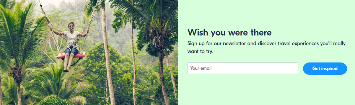 GetYourGuide's newsletter signup form, featuring an image of a young woman on a swing in a jungle