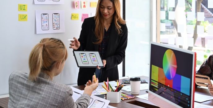 Two women discussing custom software development startup consulting