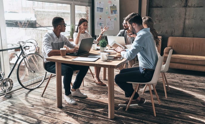 Mobile app development company experts going through a detailed quality assurance list at a team meeting