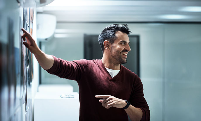 a man pointing at a whiteboard