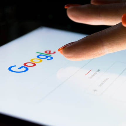 person doing Google search on a gadget