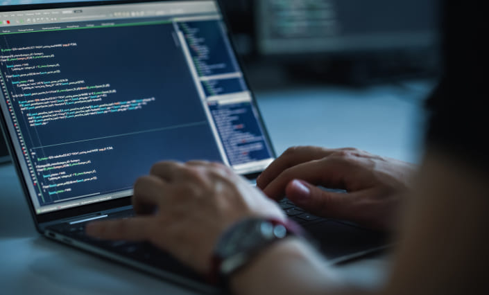 A developer codes to add to a site's technology stack