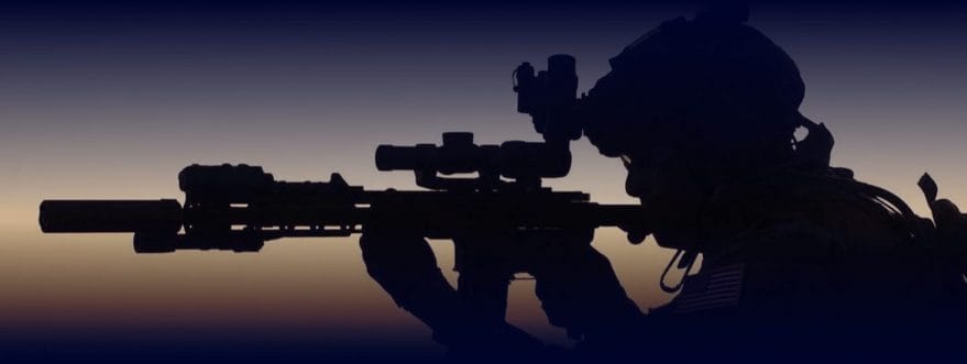 A man looks down the visor of his gun