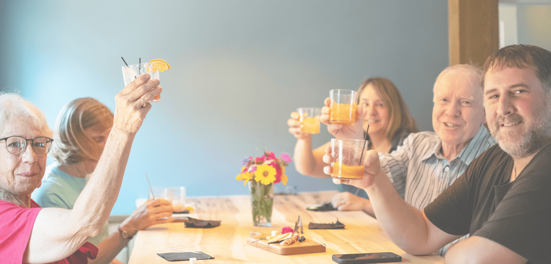 A family raise their glasses at Headwaters Restaurant & Pub