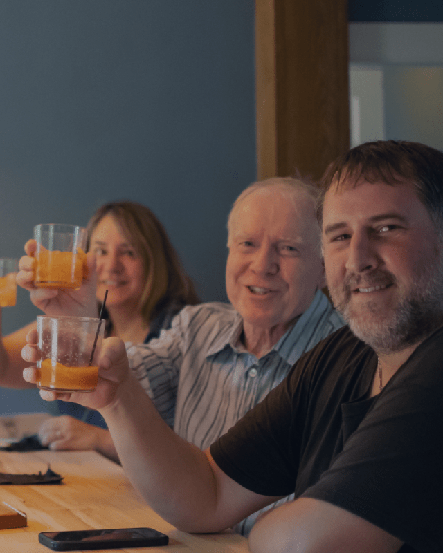 A family raise their glasses at Headwaters Restaurant & Pub