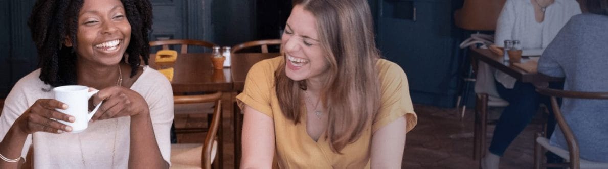 two girls drinking coffee and talking