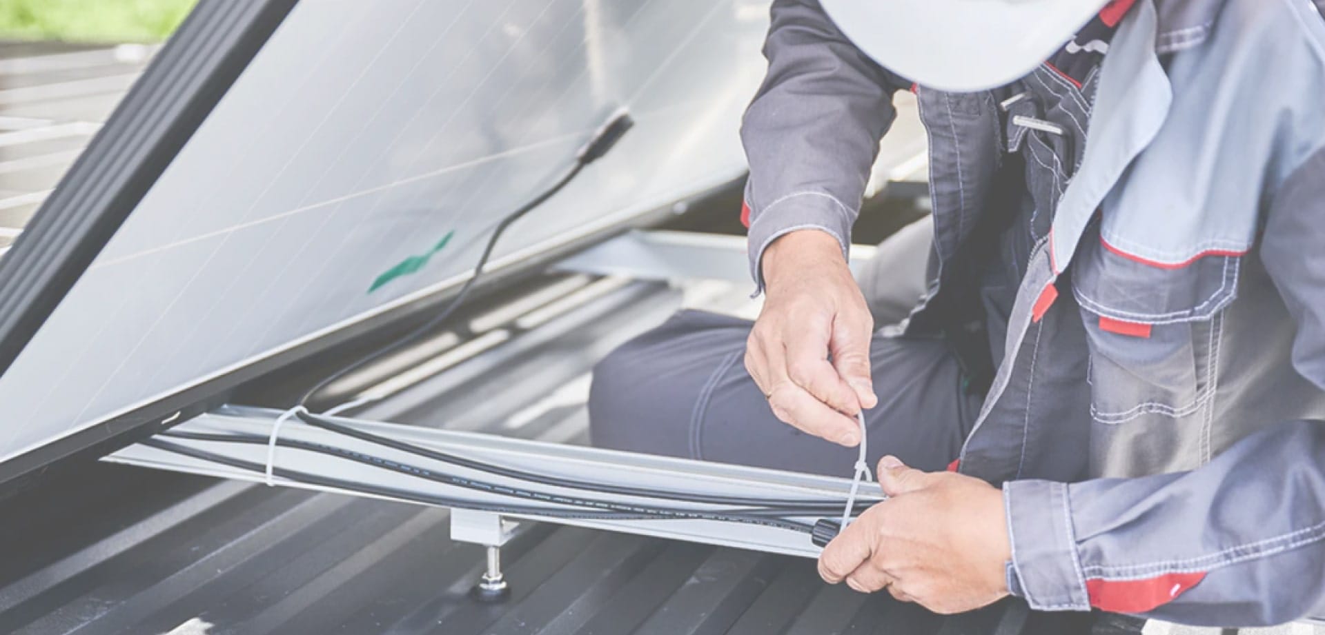 Technician securing cables with a zip tie during installation.