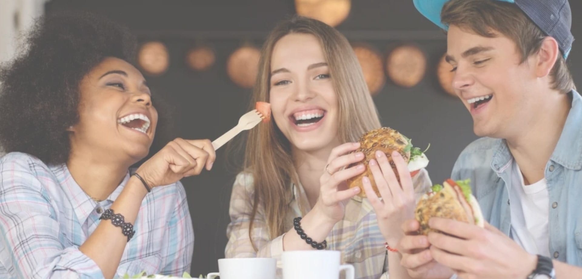 lifestyle-background-1 Image showing a group of people laughing while eating
