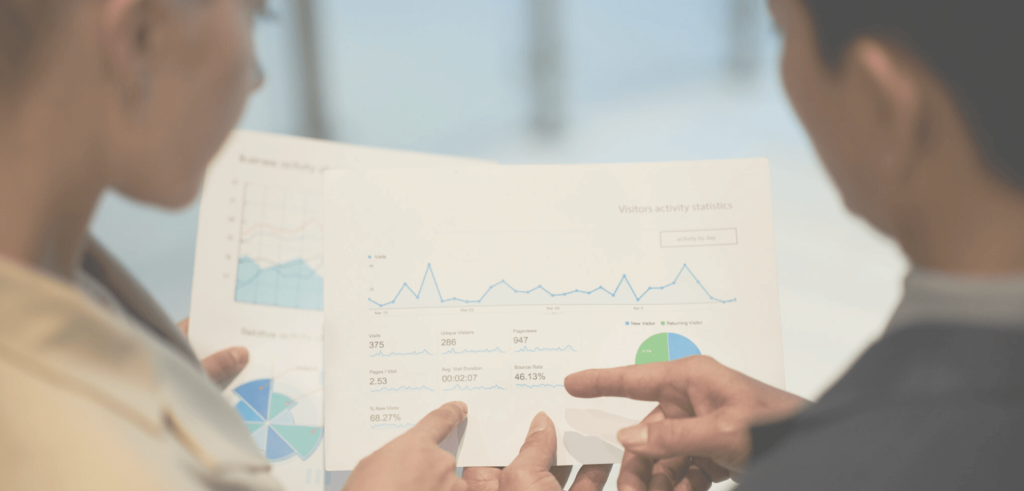 Background image for Procom's case study showing a man and a woman looking at a sheet