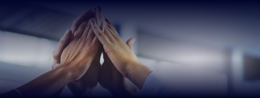 Background image for Beckway's case study showing joined hands in a group high-five