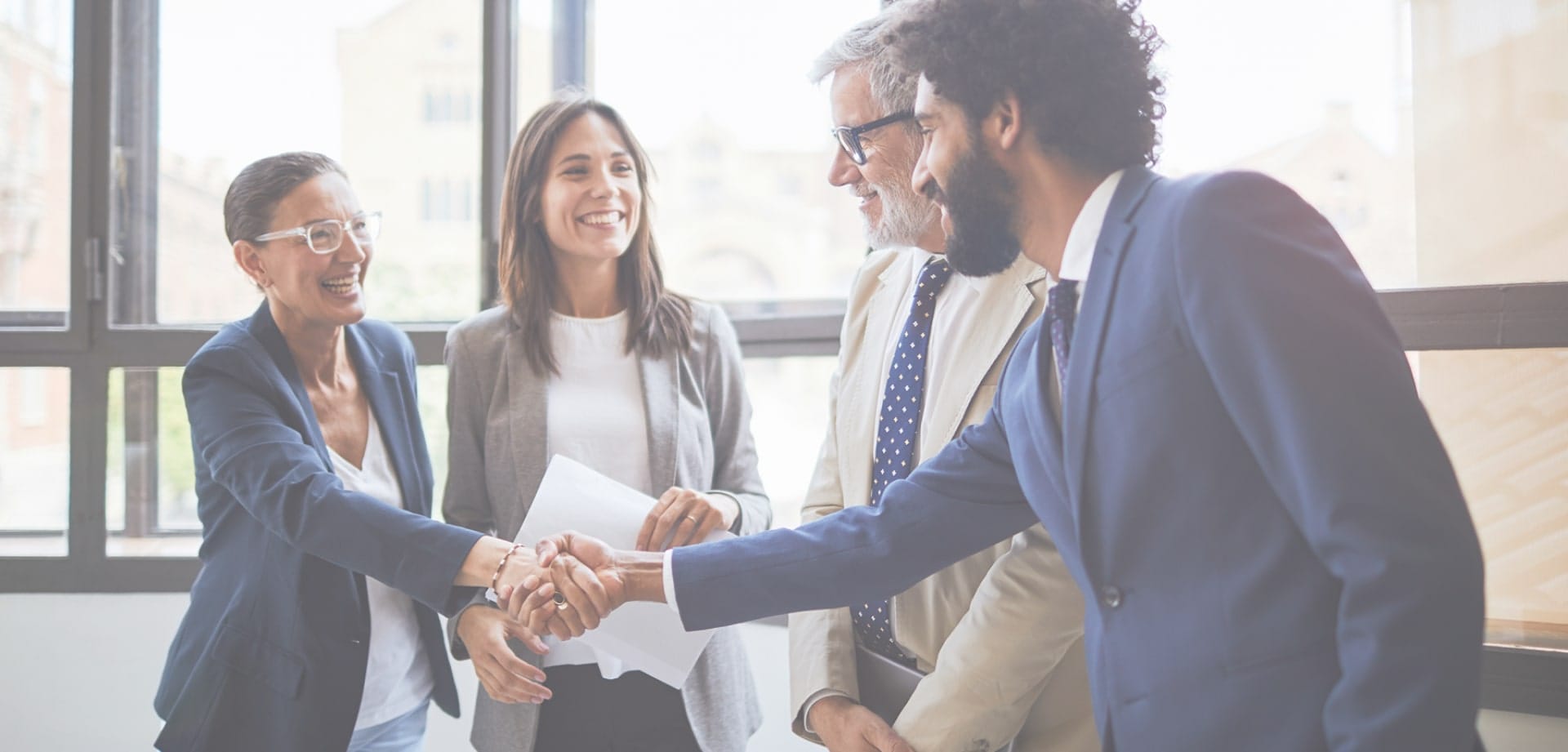 h2compliance-background-1 Background image for H2 Compiance's case study showing people in business suits shaking hands