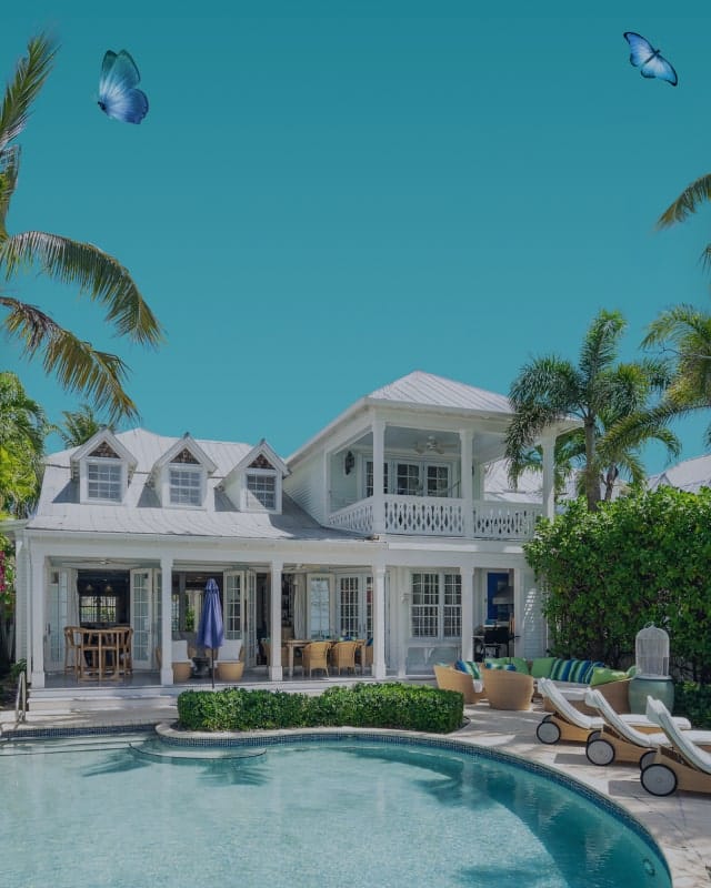Background image for Vacation Homes Of Key West's case study showing a tropical white house with a pool