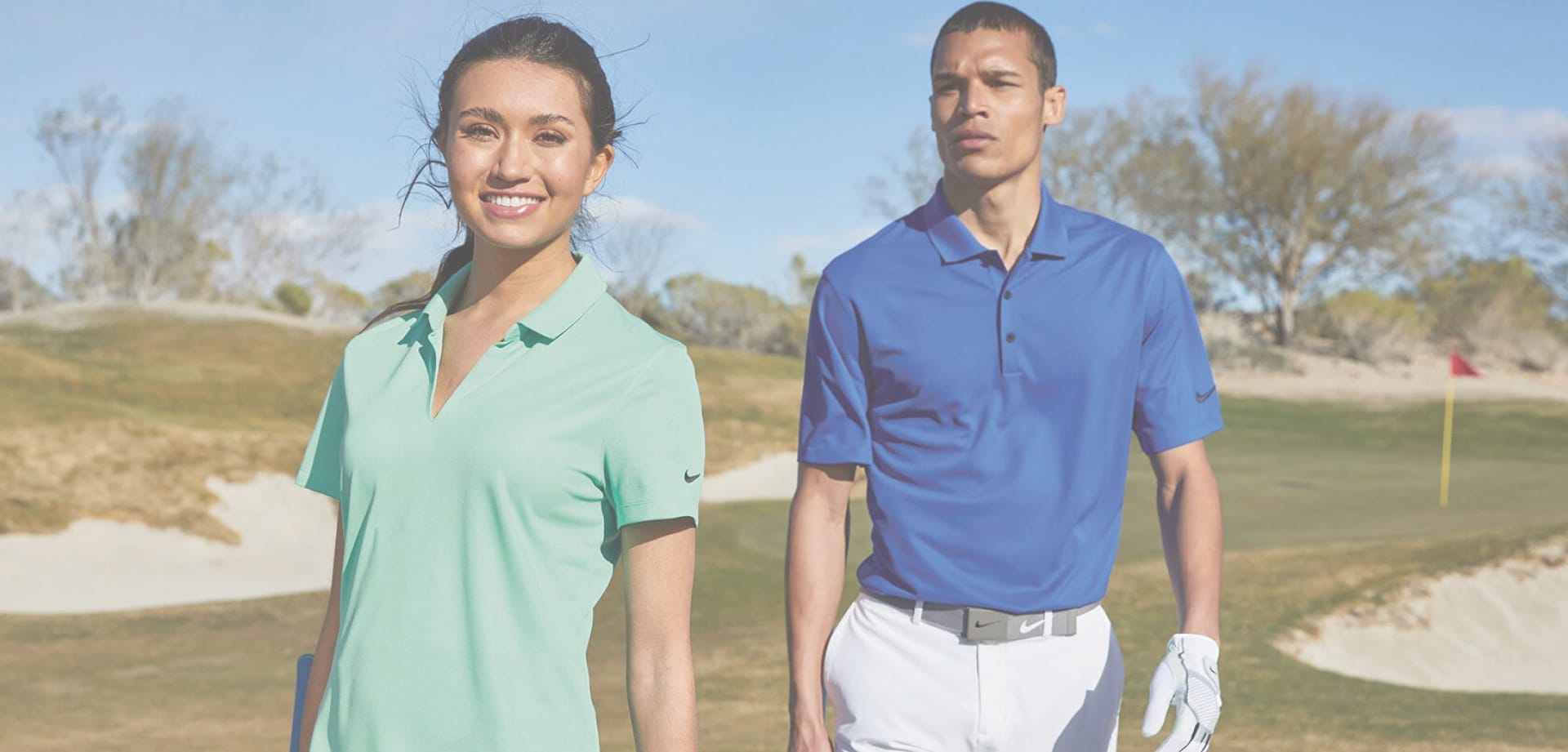 Two models in golf apparel standing on a golf course