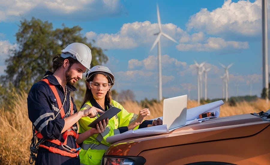 Unison 65 Image showcasing people checking wind turbine papers