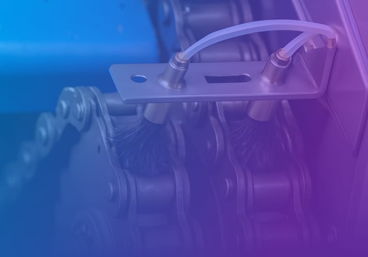 Close-up of an industrial roller chain and lubrication or cleaning mechanism