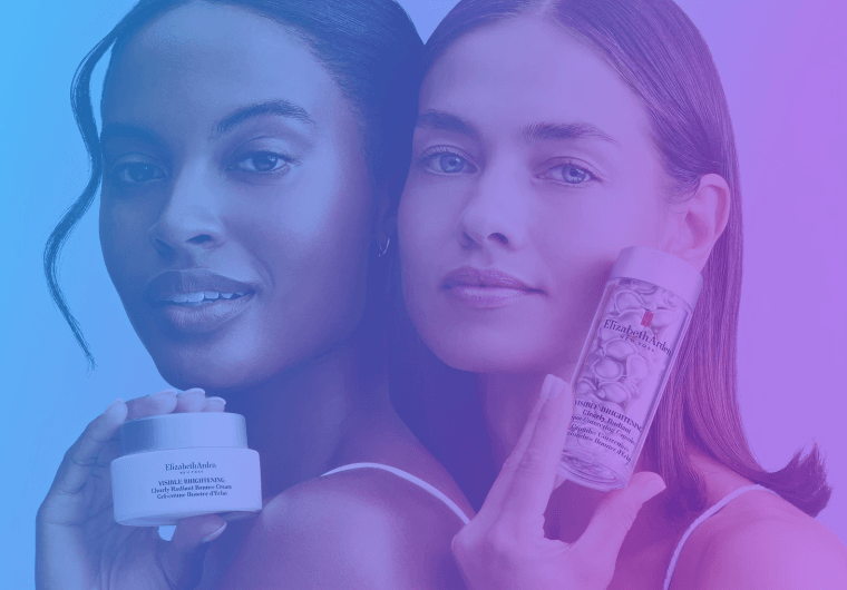 Two girls holding skincare products and smiling