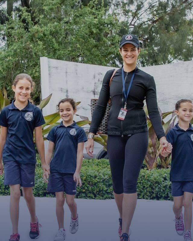 MCDS 77 Family walking outdoors with a child holding a poster, suggesting a school or community event