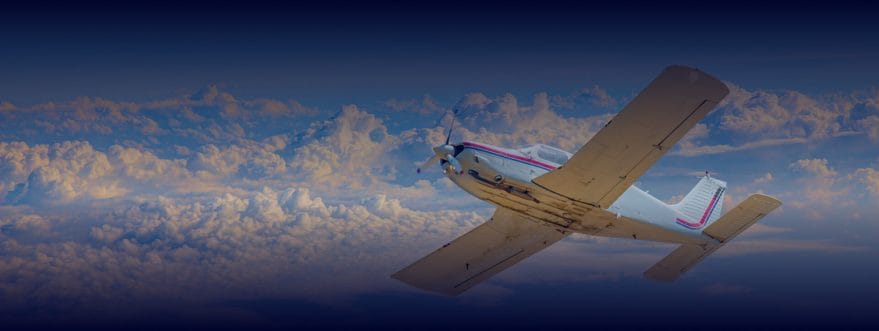 Small propeller aircraft banking in flight above a dramatic cloudscape at golden hour with a deep blue gradient overlay