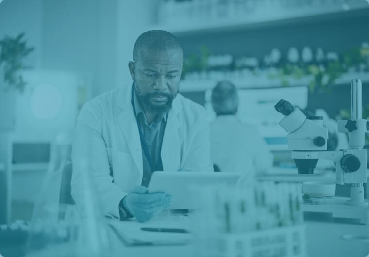 A scientist in a white lab coat reviewing data on a tablet at a laboratory workbench, with microscopes and sample racks visible nearby, overlaid with a teal color wash