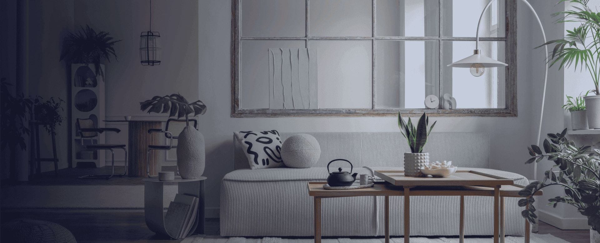 Modern living room with sofa, coffee table, lamp, and plants